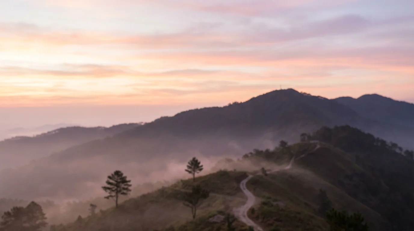 Soft sunrise over a quiet mountain ridge, evoking reverent stillness.